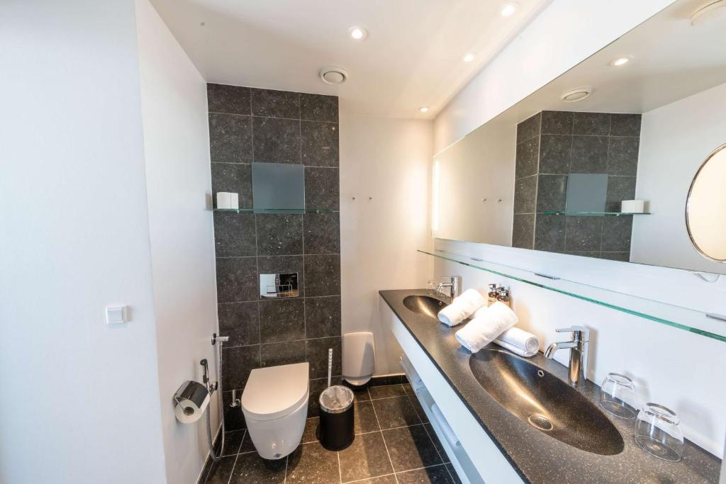 a bathroom with a sink and a toilet at Best Western Plus Hotel Ilulissat in Ilulissat