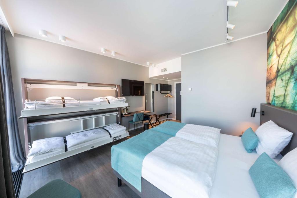 a hotel room with a bed and a desk at Best Western Plus Hotel Ilulissat in Ilulissat