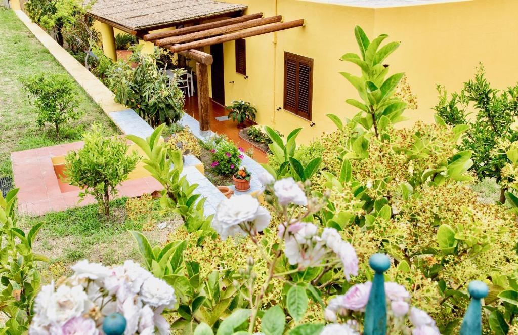 a garden with flowers in front of a house at Il Veliero Blu Lipari Centro - Guest House in Lipari