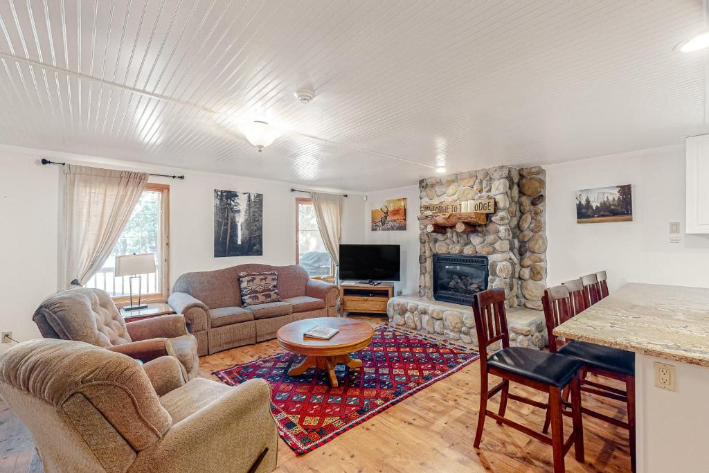 a living room with a couch and a fireplace at Oso Lodge Unit B in Yosemite West