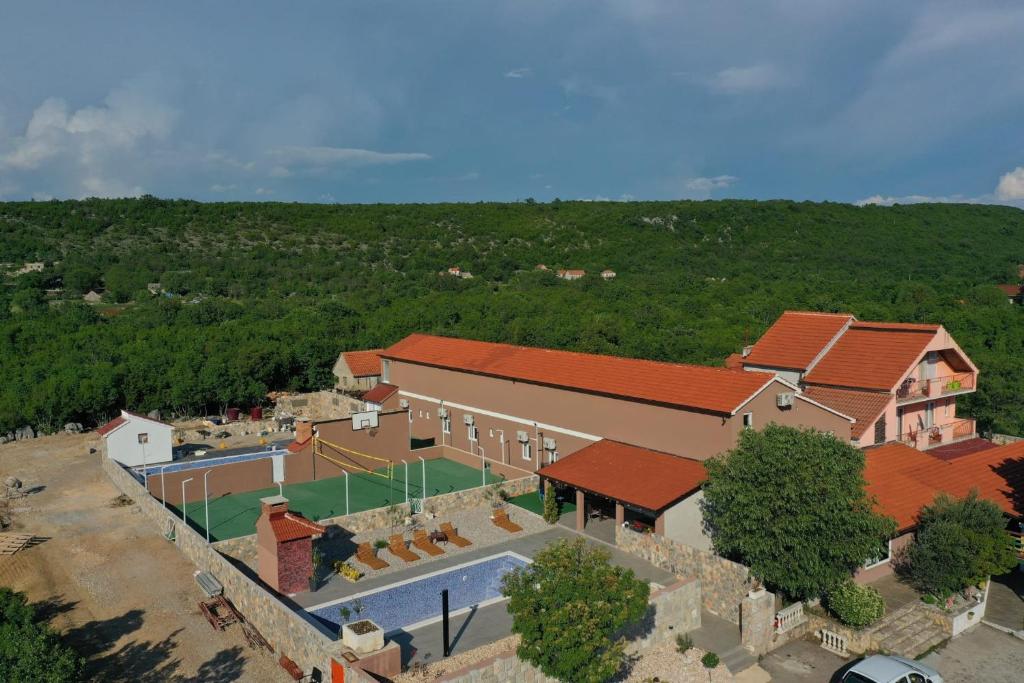 an overhead view of a building with a tennis court at Vila Matteo in Ugljane