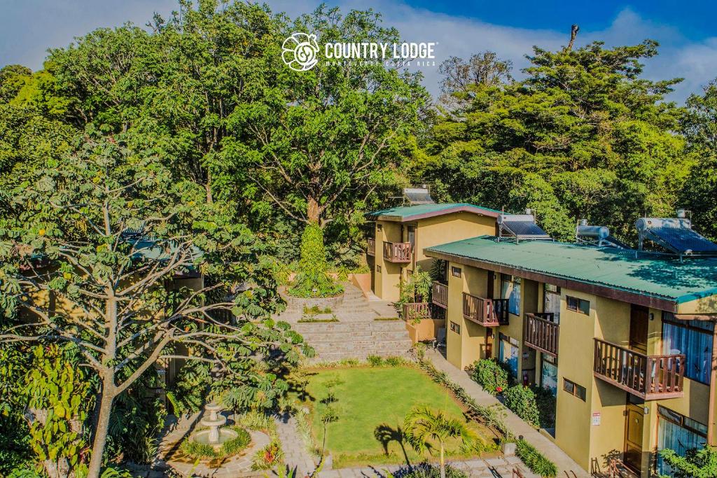 an aerial view of a house with a yard at Monteverde Country Lodge - Costa Rica in Monteverde Costa Rica