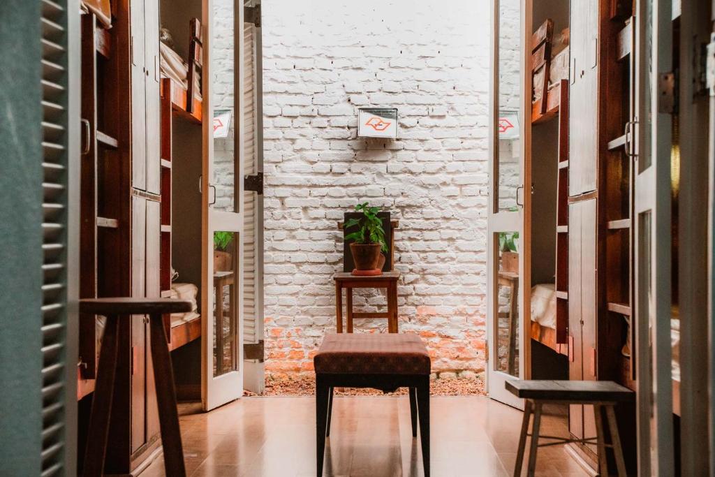 a corridor with two stools in a room at Garoa Hostel in Sao Paulo