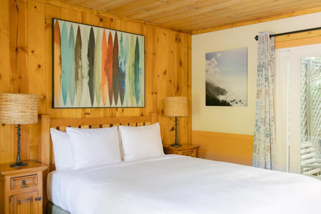 a bedroom with a white bed and a window at Fernwood Resort in Big Sur