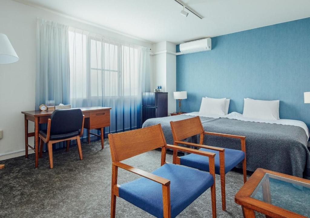 Postel nebo postele na pokoji v ubytování Hotel Graphy Nezu