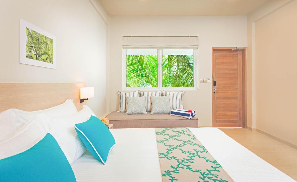 Postel nebo postele na pokoji v ubytování Malahini Kuda Bandos Resort