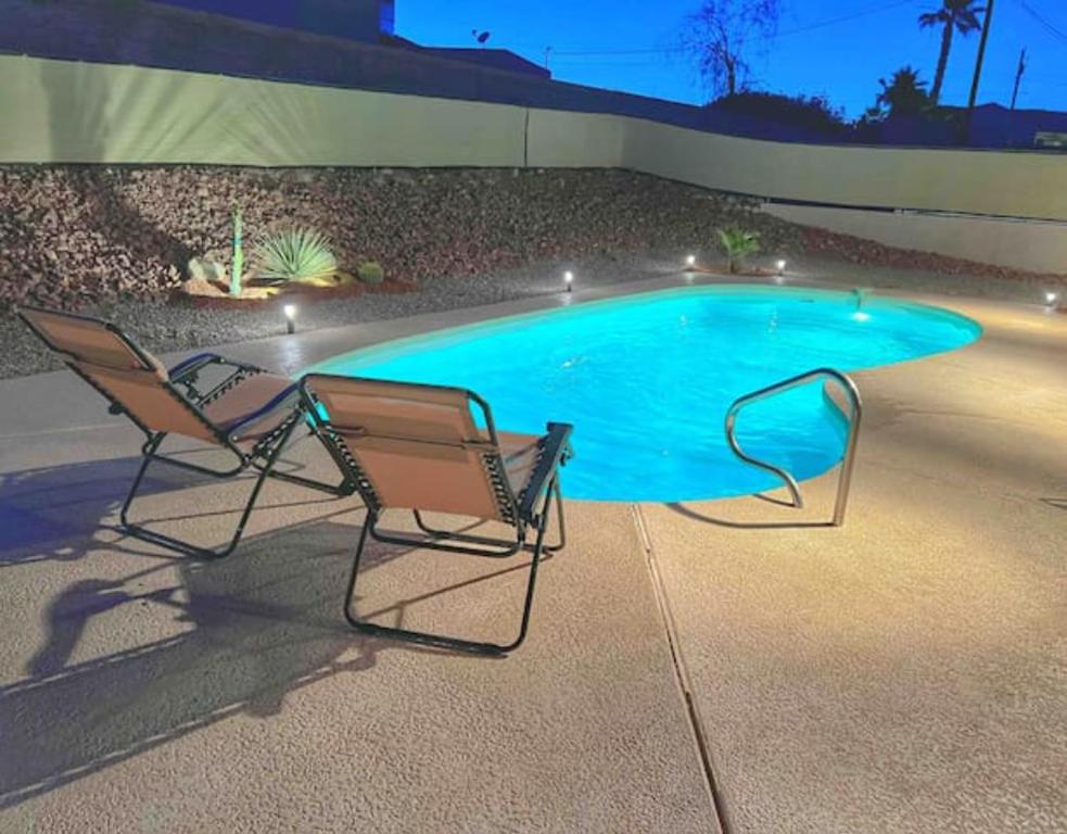 two chairs sitting in front of a swimming pool at Relax and Unwind - Pool - New - Central - Spacious in Lake Havasu City
