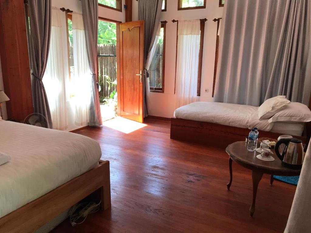 Postel nebo postele na pokoji v ubytování Padi Ecolodge