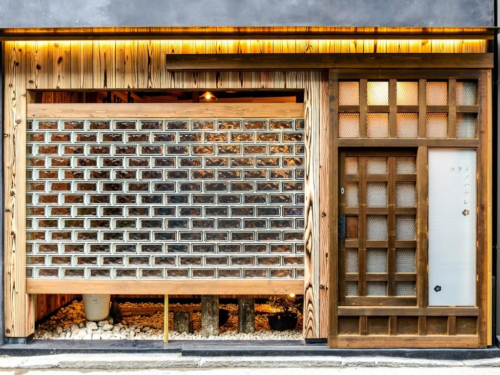 a display window of a brick building with a white door at Koume no Hanare コウメノハナレ in Kyoto