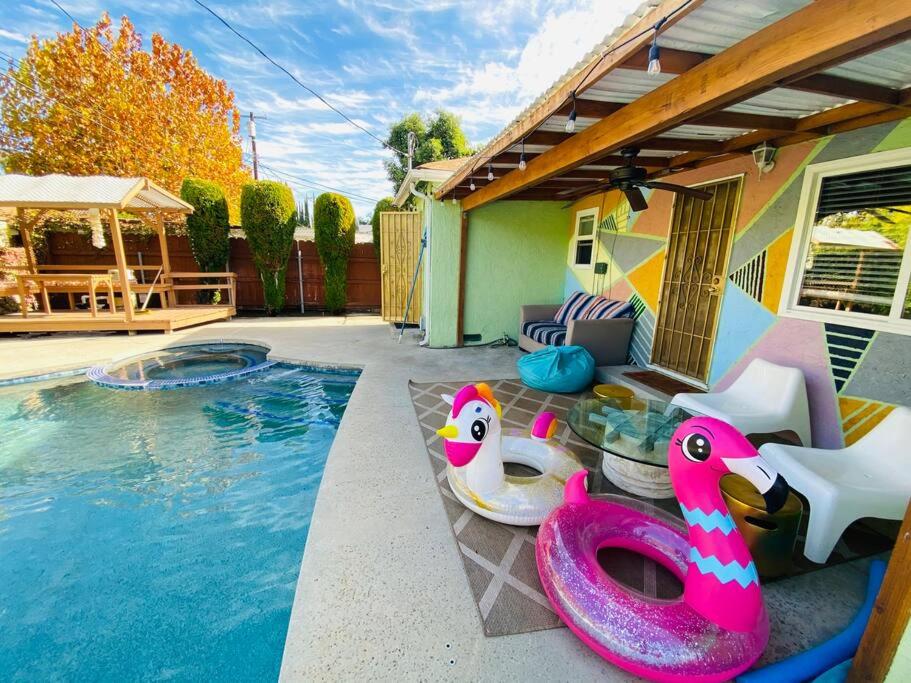 a house with a swimming pool with a pool noodleitatingitatingitatingitatingitating at Endless summer in LA *HEATED POOL/HOT TUB/CABANA* in Los Angeles