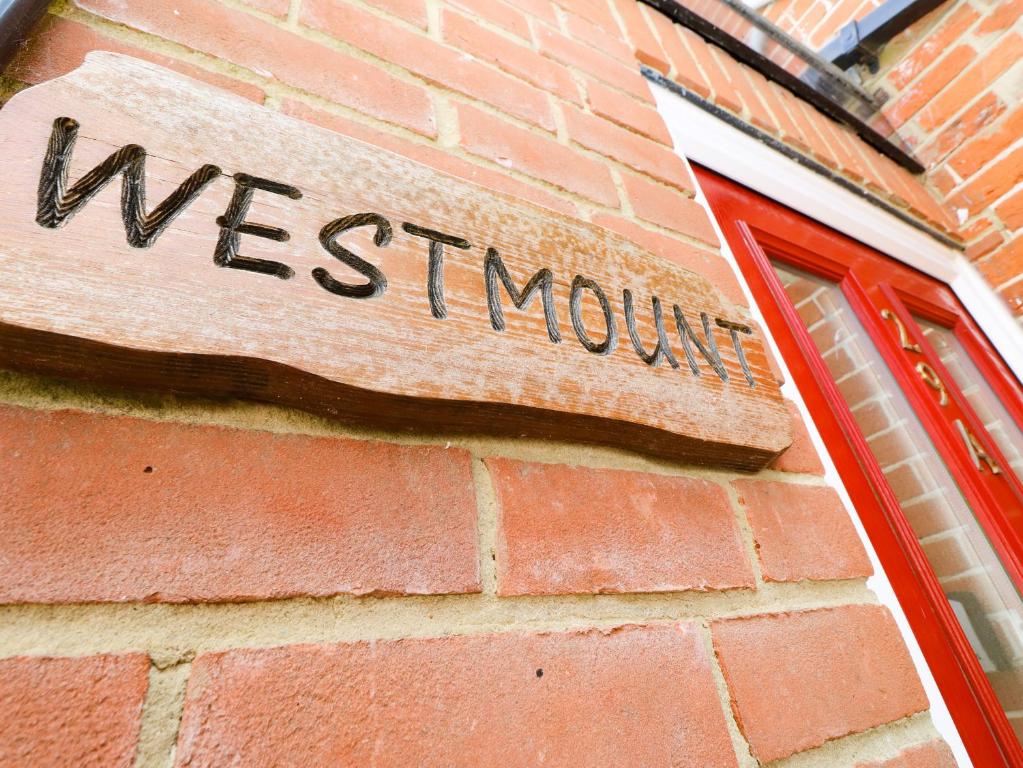 a sign on the side of a brick building at Westmount in Ryde