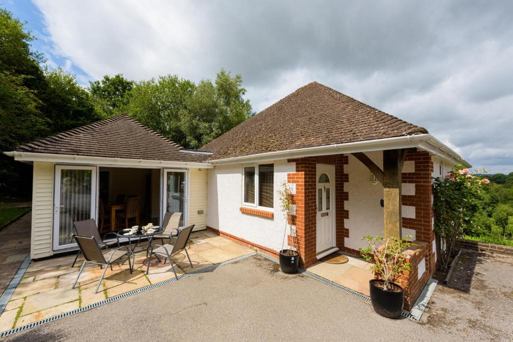 a house with a patio with a table and chairs at Heath Retreat in Uckfield