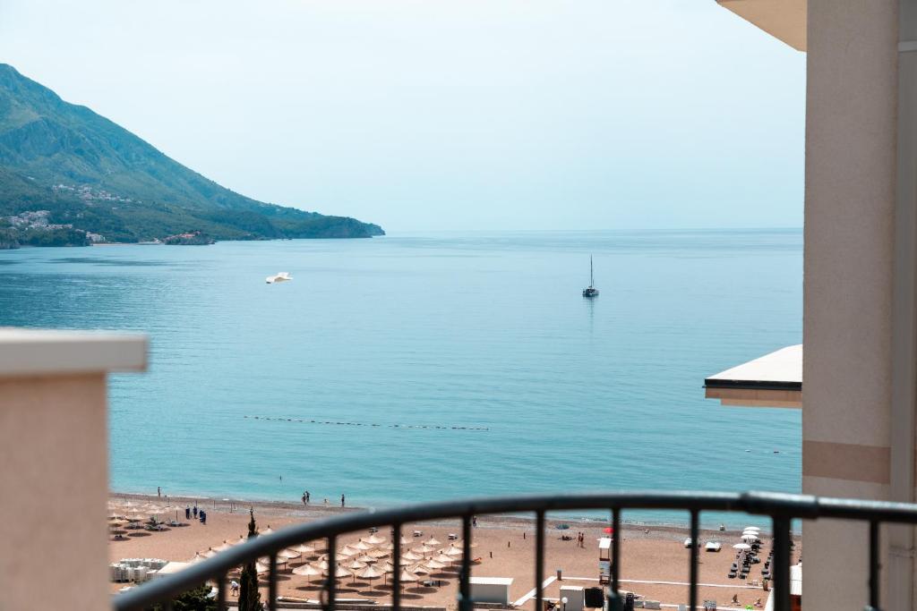a view of a beach and the ocean from a balcony at Porta Volta Residence in Bečići