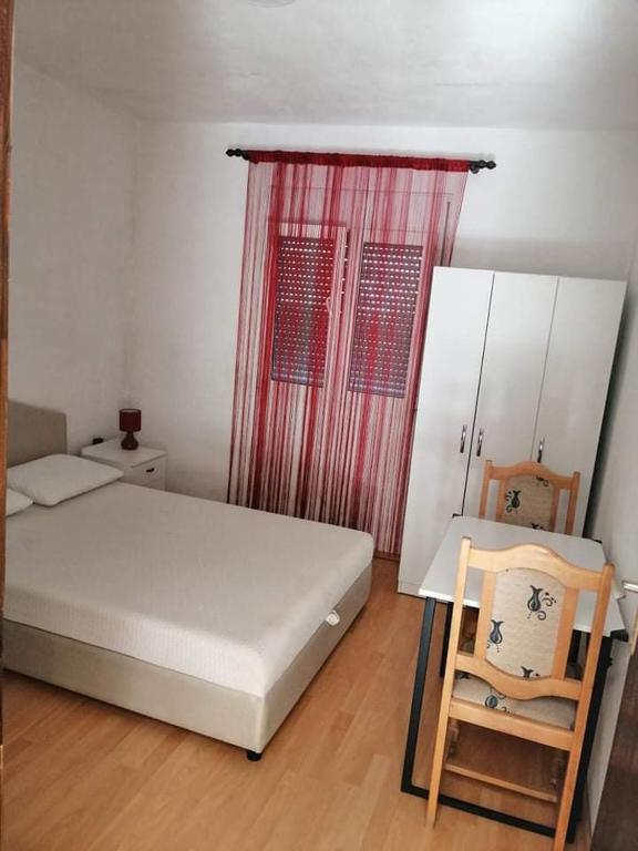 a small bedroom with a bed and a chair at Apartment’s Maric - Zelenika,Herceg Novi in Zelenika