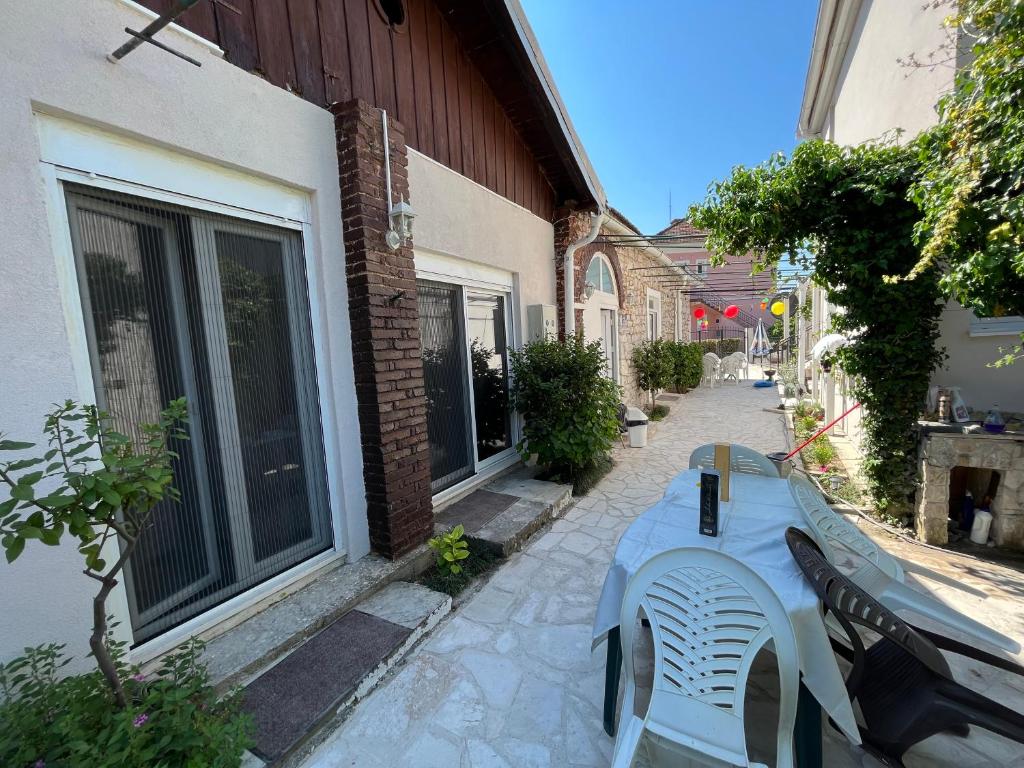 a bench sitting on a sidewalk next to a building at Apartment’s Maric - Zelenika,Herceg Novi in Zelenika