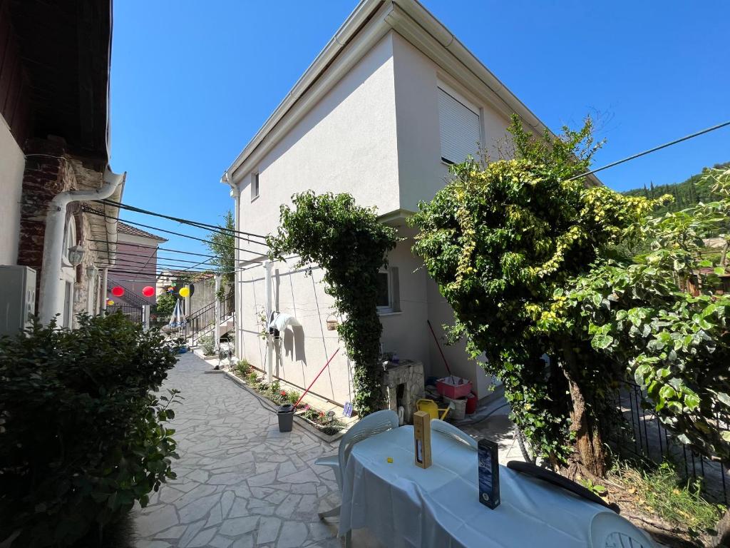 a small white building with a fence next to a street at Apartment’s Maric - Zelenika,Herceg Novi in Zelenika