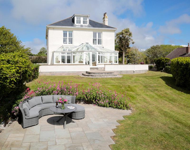 a house with a couch and a table in the yard at The Haven in Polzeath