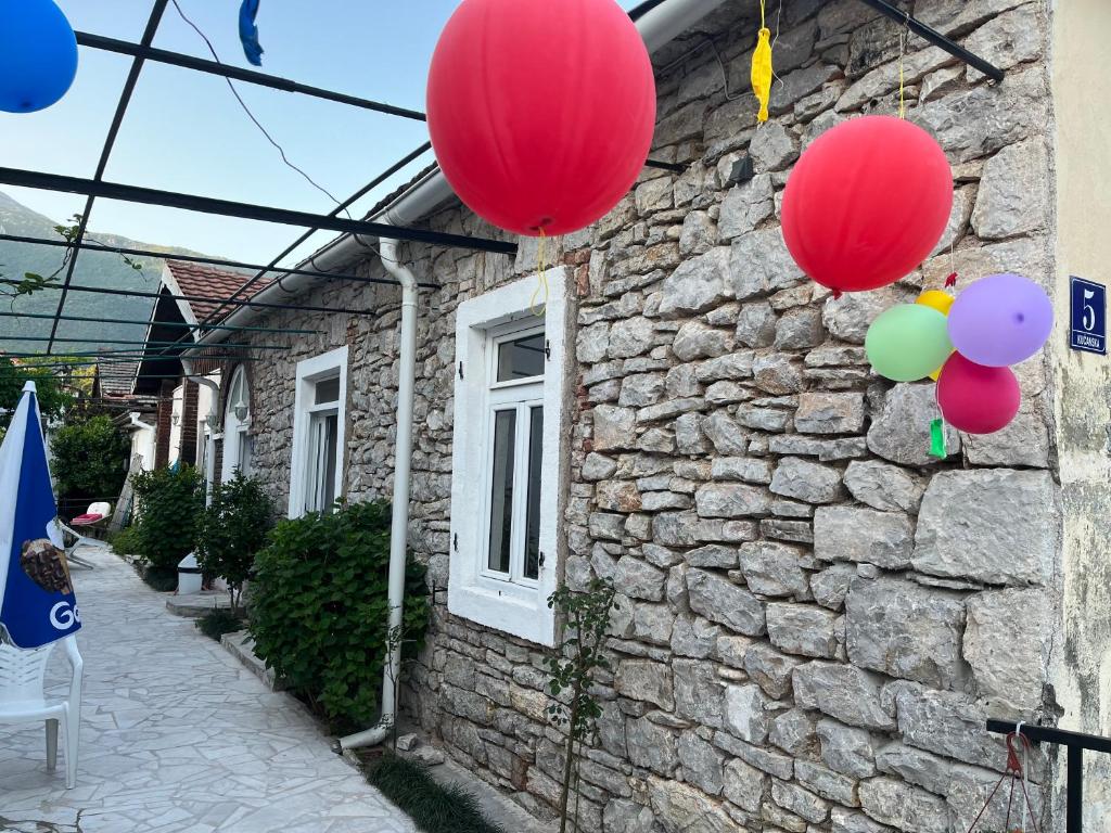 a group of balloons hanging from a stone house at Apartment’s Maric - Zelenika,Herceg Novi in Zelenika