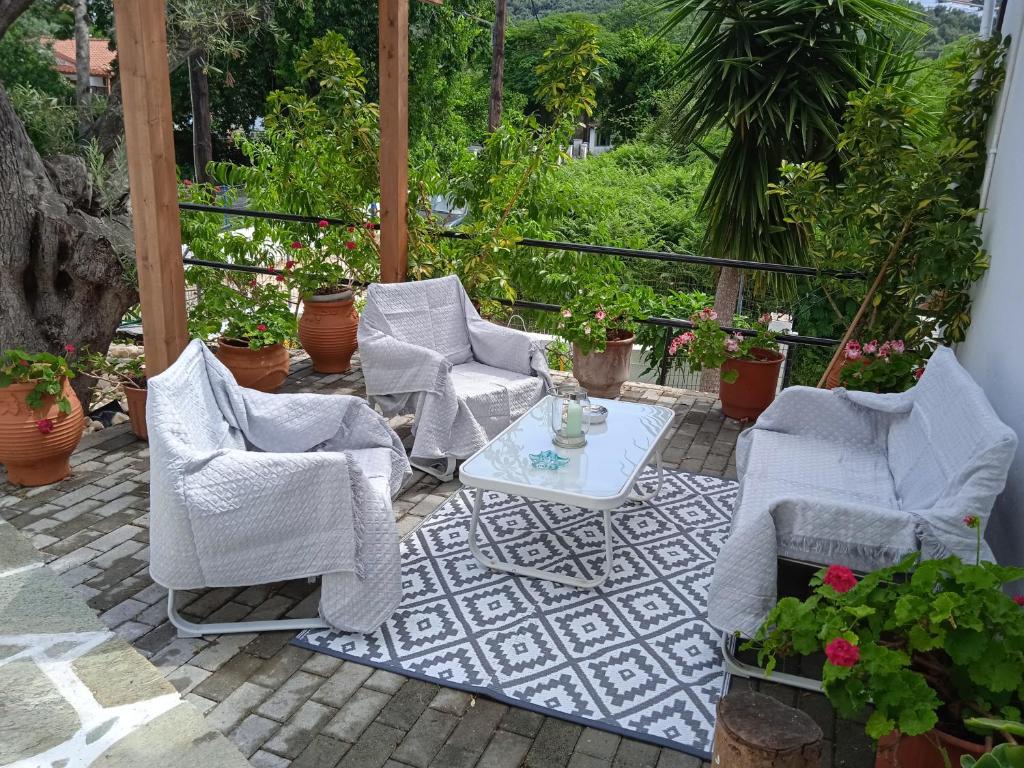 a group of chairs and a table on a patio at Adam's House in Achladies