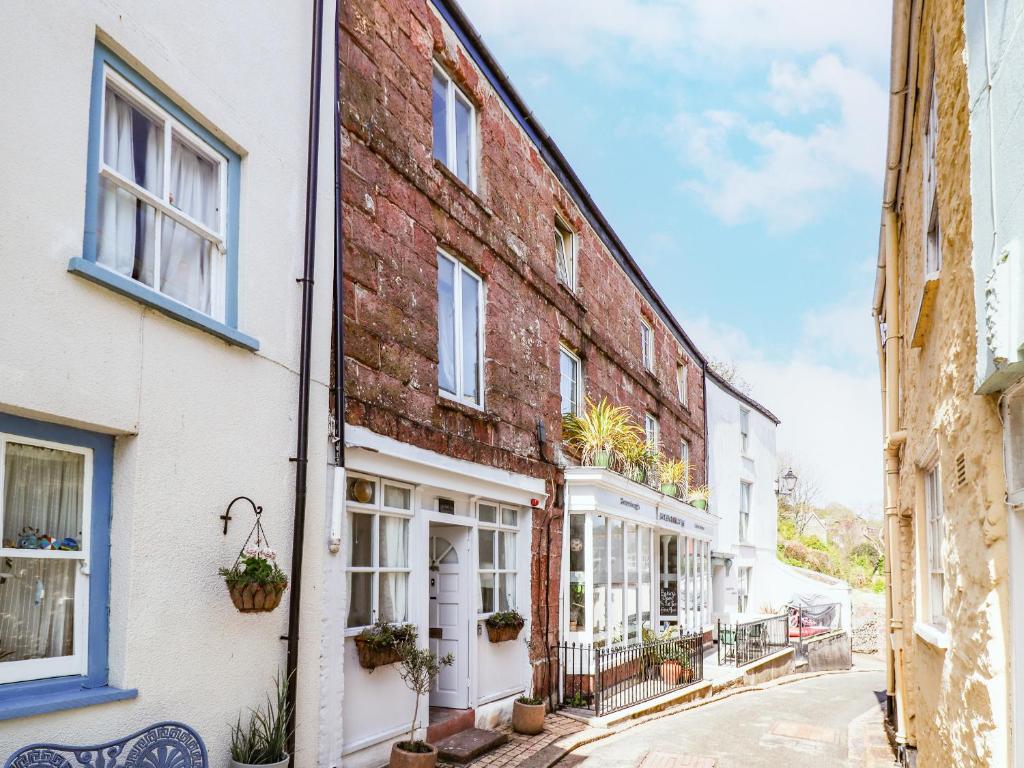 an alley in an old town with buildings at Garretts in Torpoint