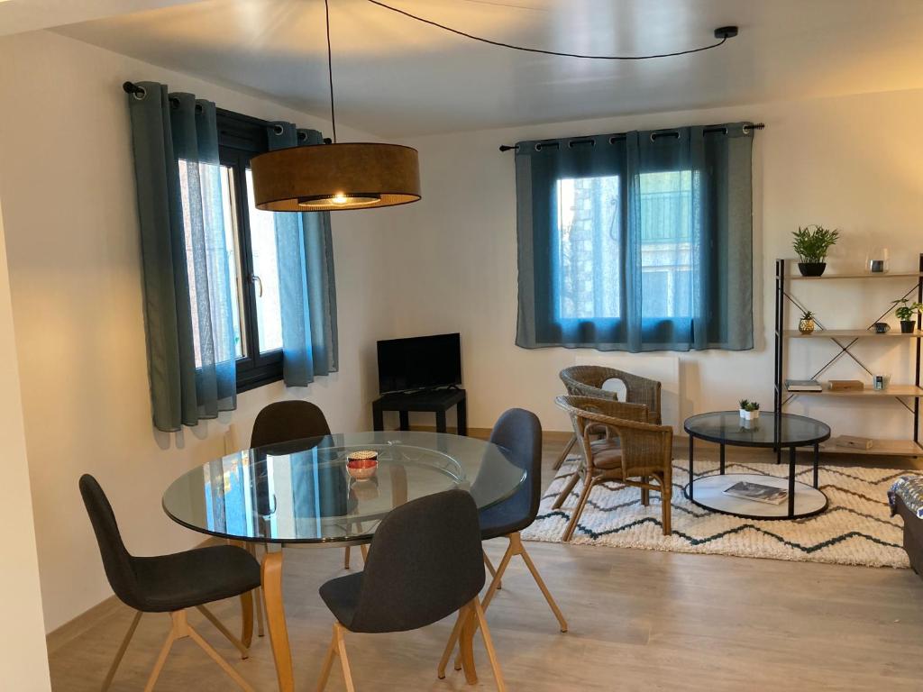 a living room with a glass table and chairs at Appartement en centre ville avec roof top in Port-la-Nouvelle