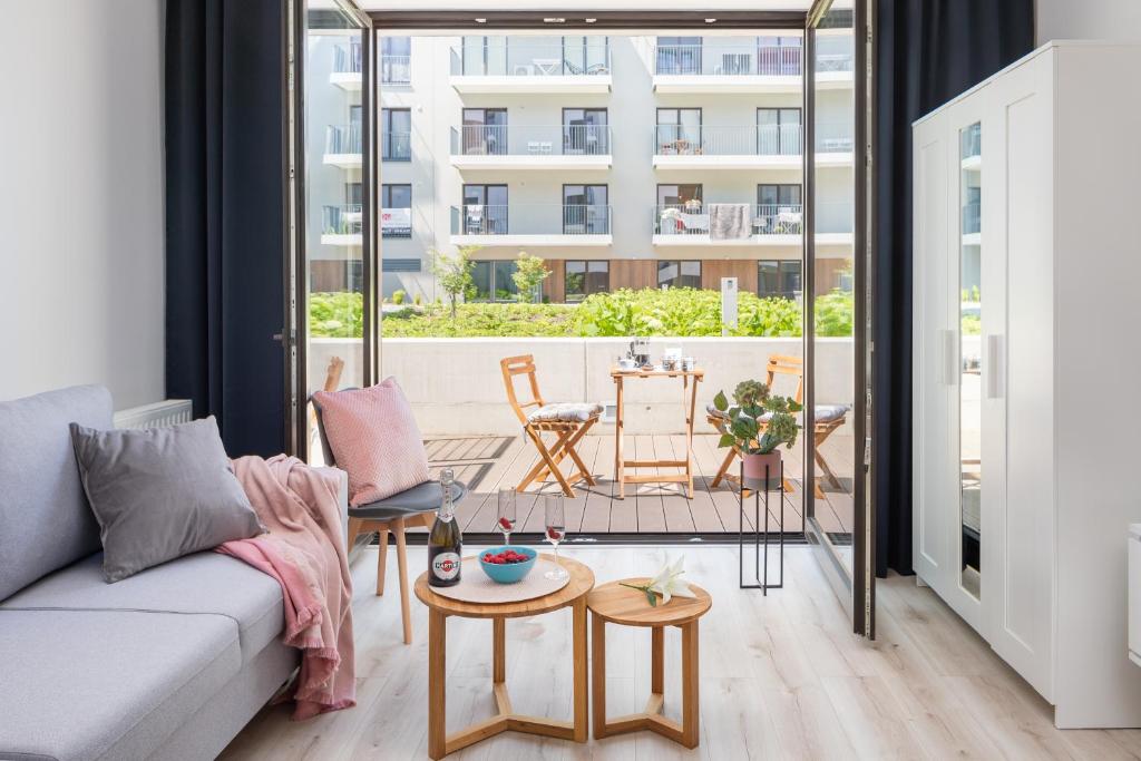 a living room with a couch and a table at Rent like home - River City Apartments in Wrocław