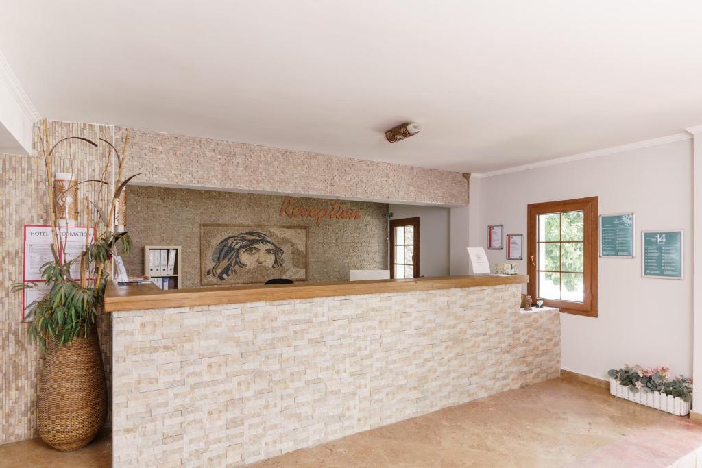 a bar in a room with a brick wall at Costa Bitezhan Hotel - All Inclusive in Bitez