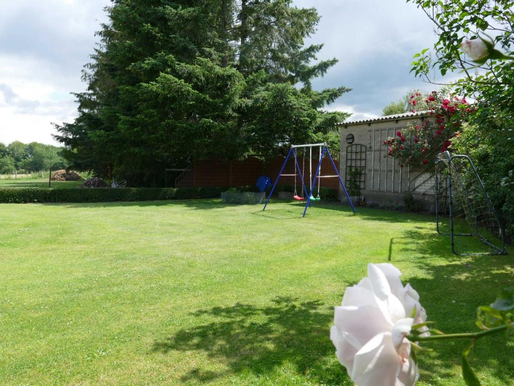 a yard with a playground and a tree at Ferienwohnung "Zur Schmiede" Objekt-ID 11824 in Torgelow am See