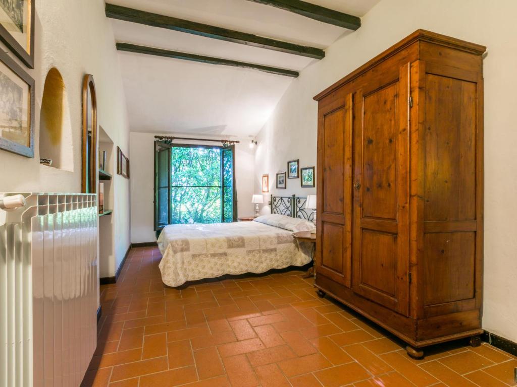 sypialnia z łóżkiem i dużą drewnianą szafką w obiekcie Holiday Home Bardeggiano - Caterina 8 - COL243 by Interhome w mieście Belvedere