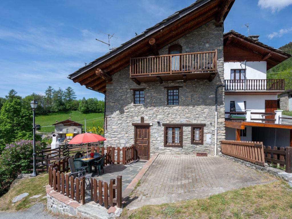 Cette grande maison en pierre dispose d'un balcon et d'une clôture en bois. dans l'établissement Apartment Caillod 12 by Interhome, à Sarre