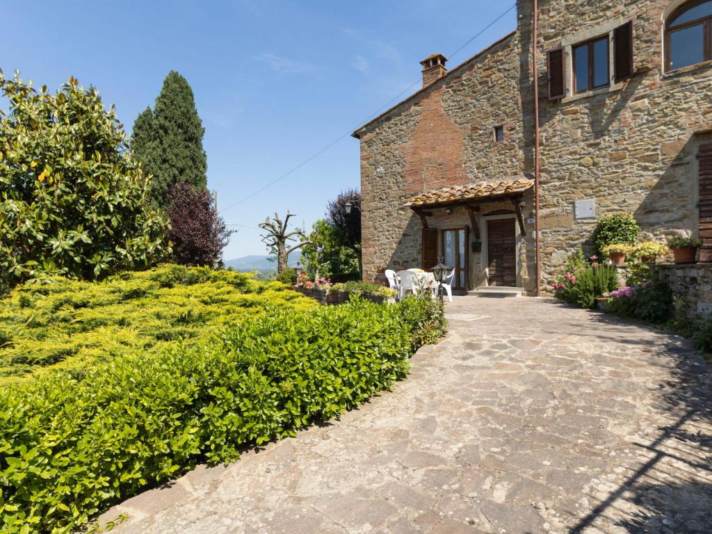 a stone house with a cow standing outside of a building at Holiday Home La Casina by Interhome in Pieve a Maiano