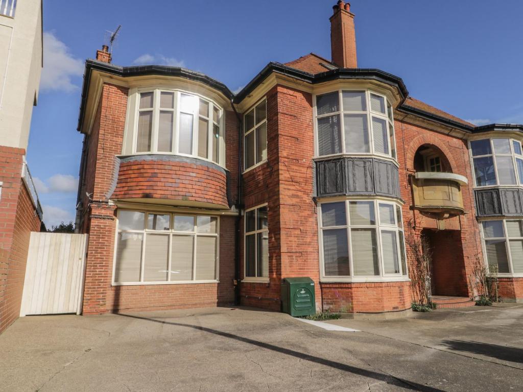 un edificio de ladrillo rojo con ventanas blancas en una calle en Atelier, en Bridlington