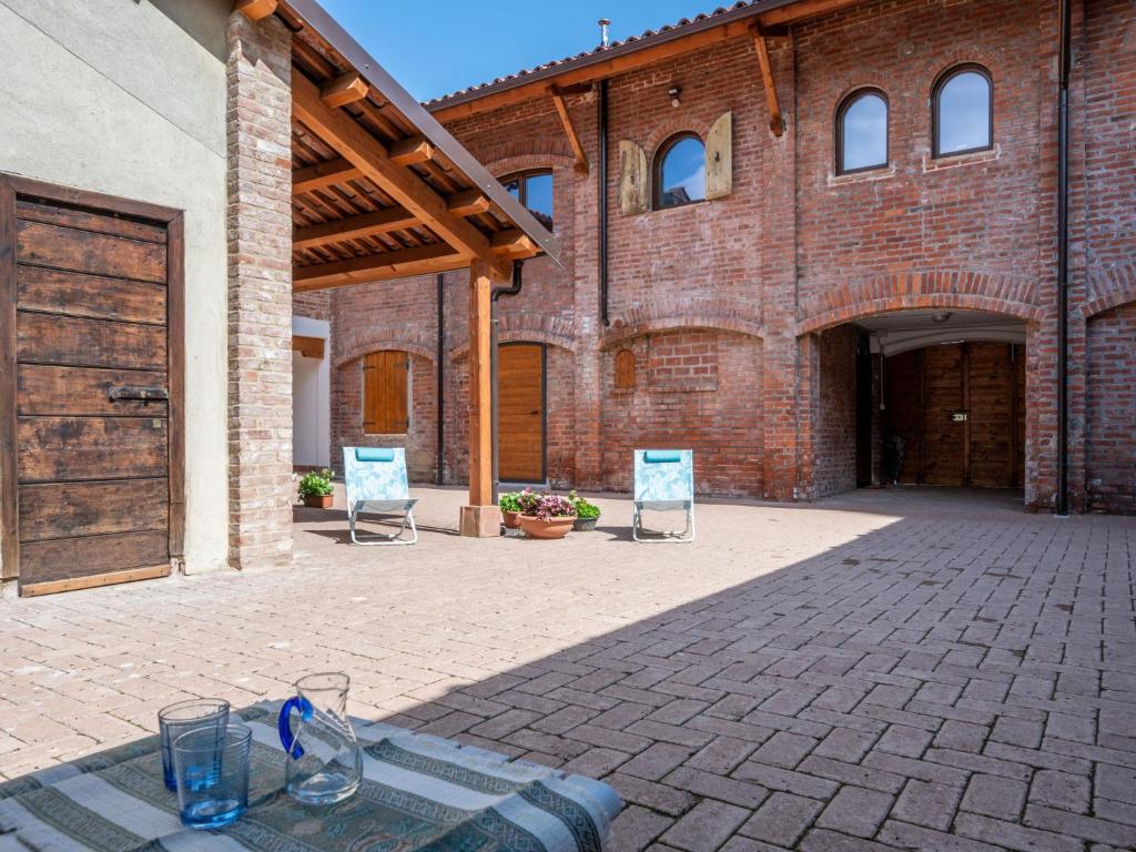 a brick building with two chairs and a table at Apartment La Quercia by Interhome in Mondovì