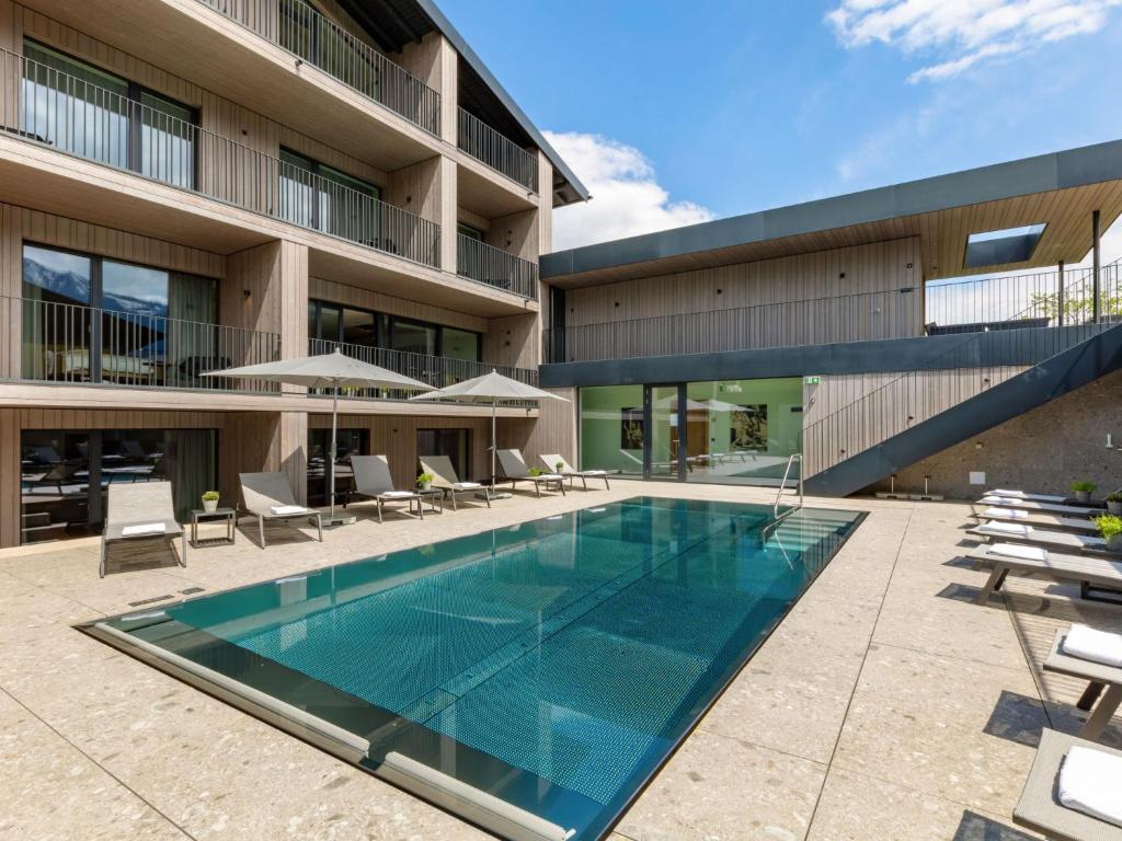 a swimming pool in front of a building at Apartment Emma Deluxe Aparthotel-8 by Interhome in Fürth