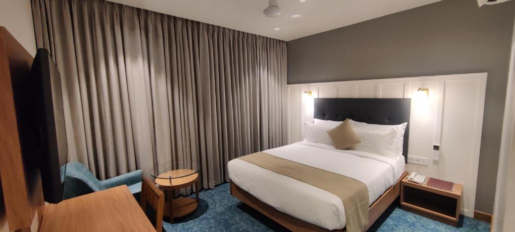 Un pat sau paturi într-o cameră la Chryso Hotels Pvt Ltd