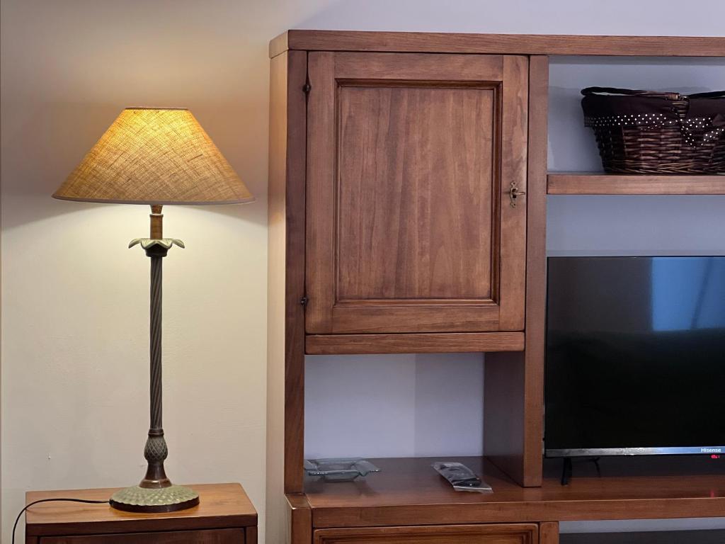 a lamp sitting on a table next to a tv at Provenzano Studios in Siena