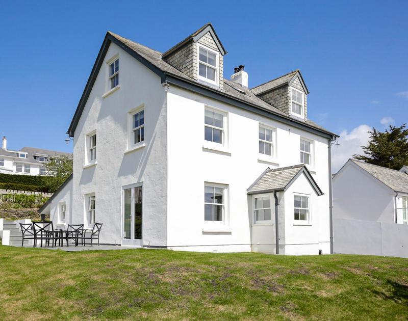 a large white house on a grass field at Black Rock House in Padstow
