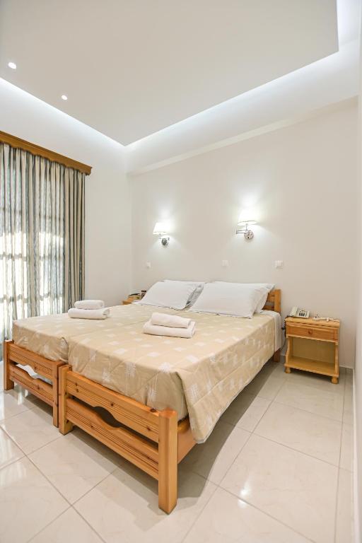 Postel nebo postele na pokoji v ubytování Hotel Zeus