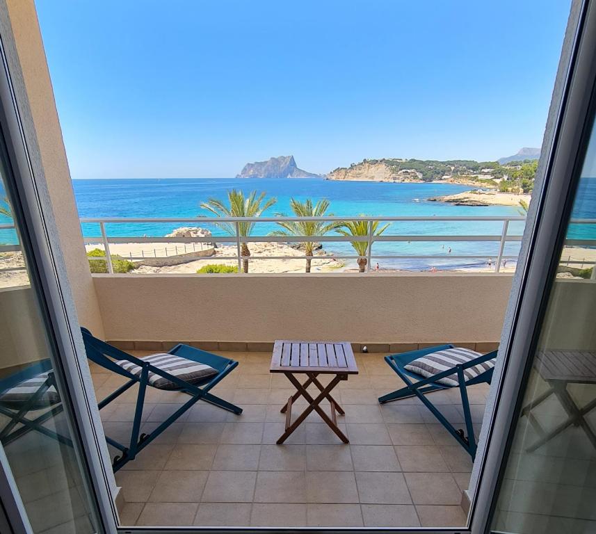 a balcony with chairs and a view of the beach at Moraira Beach in Moraira