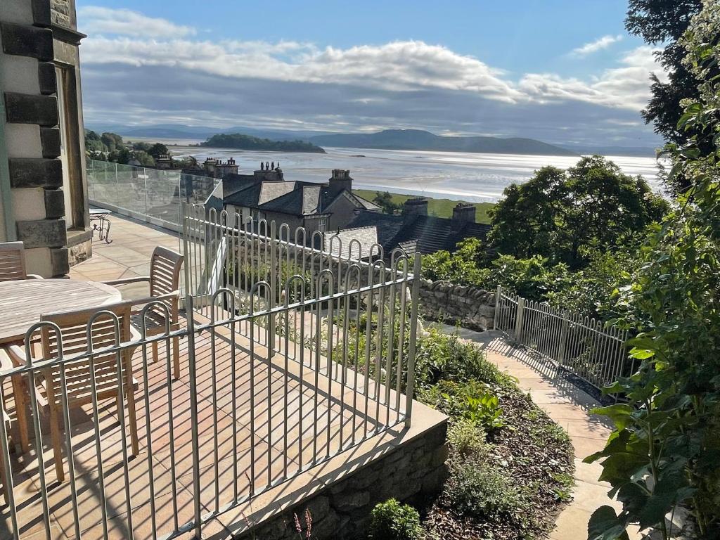 a balcony of a house with a view of the ocean at Victoria Mount in Grange Over Sands