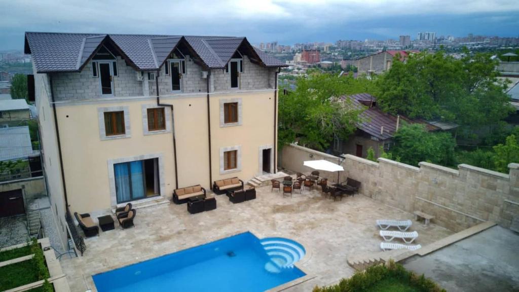 an aerial view of a house with a swimming pool at Villa De France in Yerevan