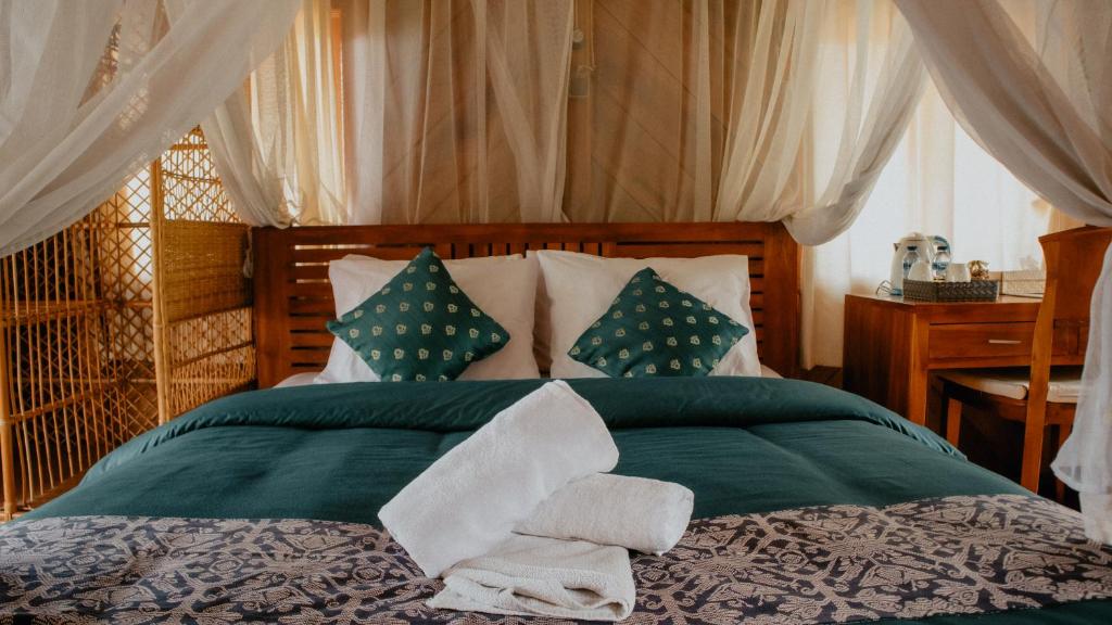 Postel nebo postele na pokoji v ubytování Puri Sunny Guesthouse