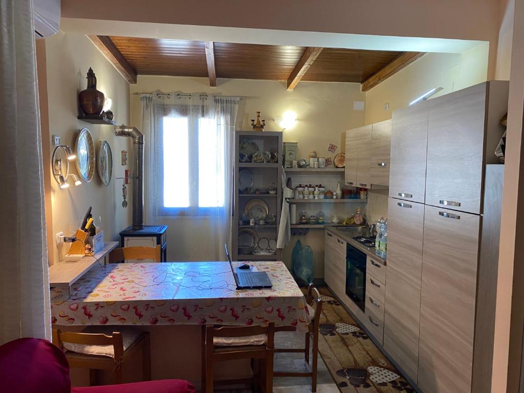 Il comprend une cuisine équipée d'une table, de chaises et d'un réfrigérateur. dans l'établissement Luxury Villa Barbara, à Reggio de Calabre