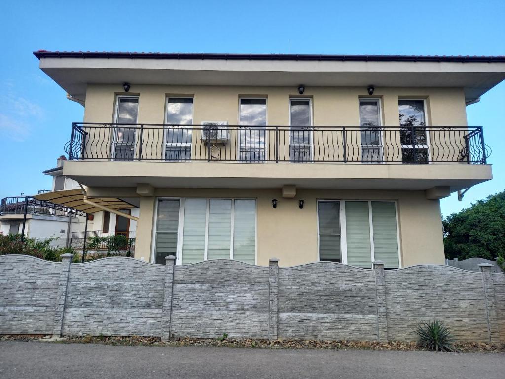 a large house with a fence in front of it at вила ФЛОРА in Chernomorets