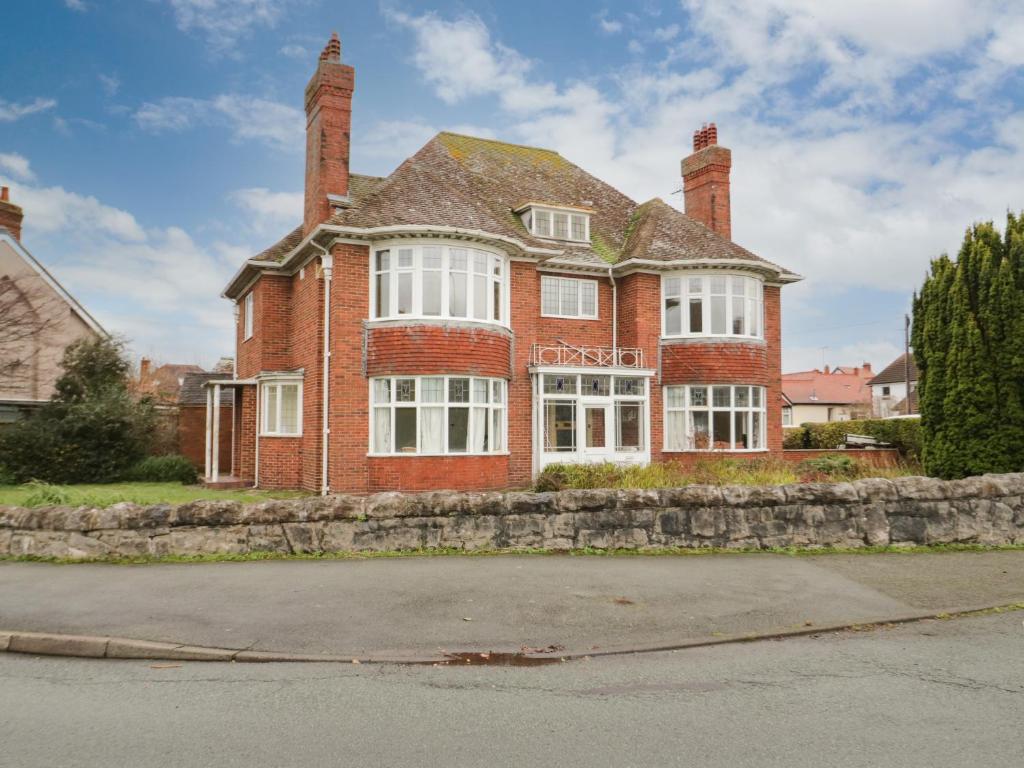 a large red brick house with two chimneys at Seawinds in Colwyn Bay