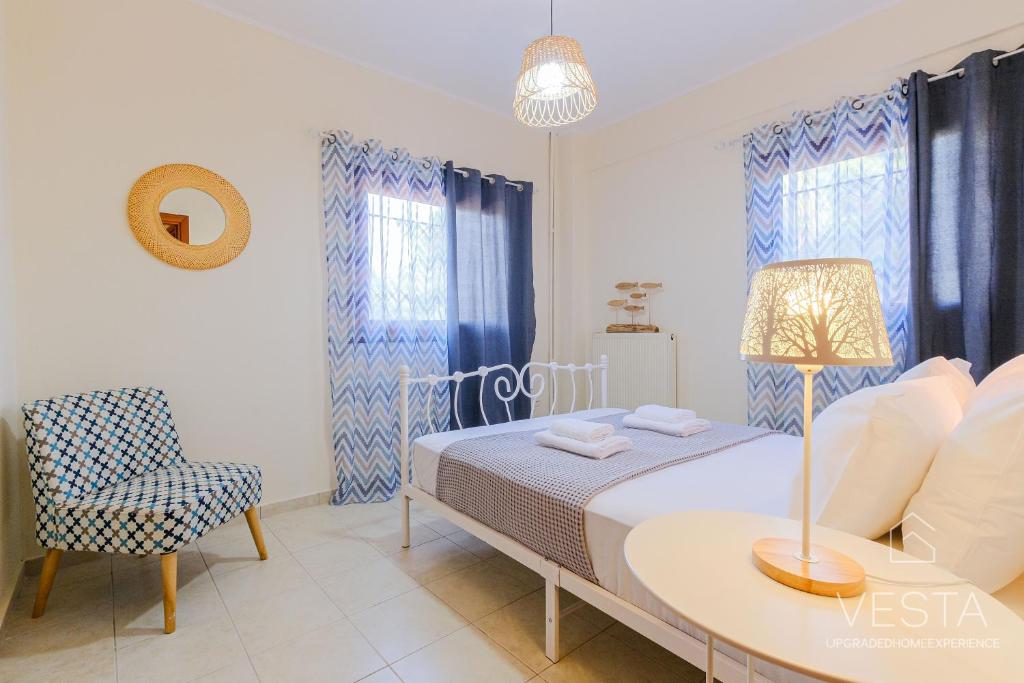 a bedroom with a bed and a table and a chair at Green Gem Apartments with 2 bdrms, Afytos in Afitos