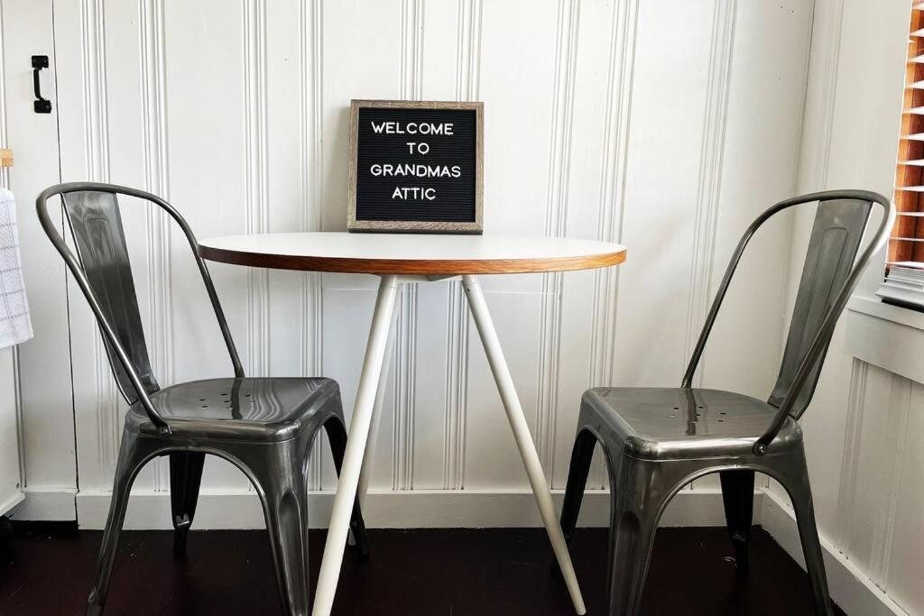 a table with two chairs and a sign on it at Grandma's Attic in Lakewood