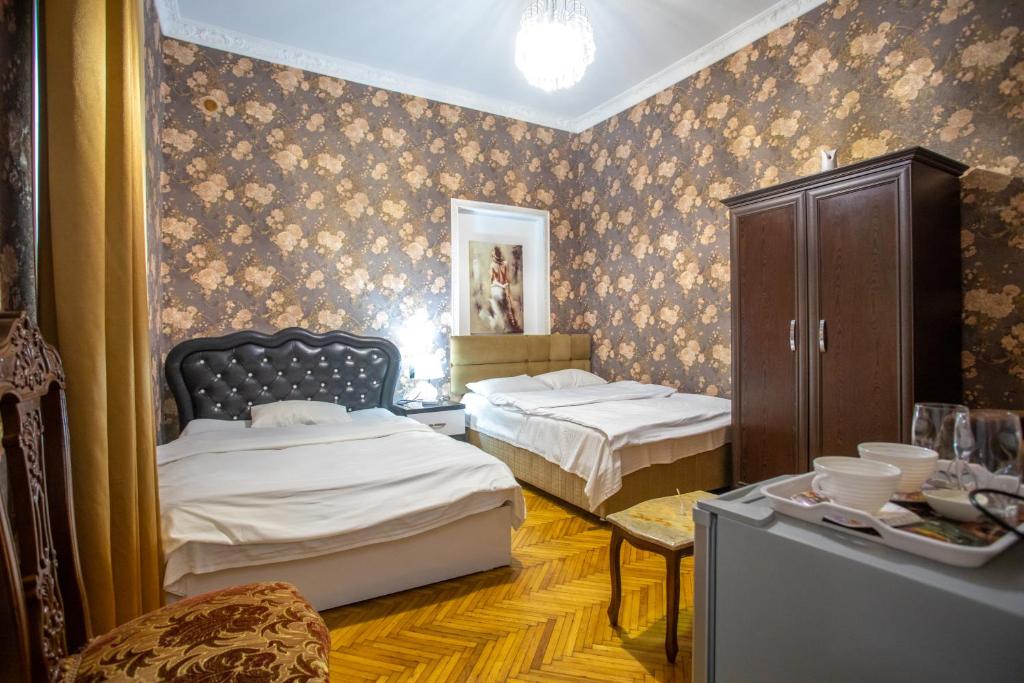 Postel nebo postele na pokoji v ubytování HOTEl MKUDRO