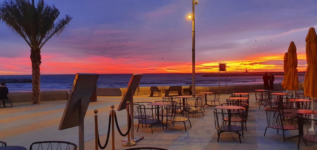 a group of tables and chairs on the beach at sunset at beau t2 proche plage et commerces, logia in La Grande Motte