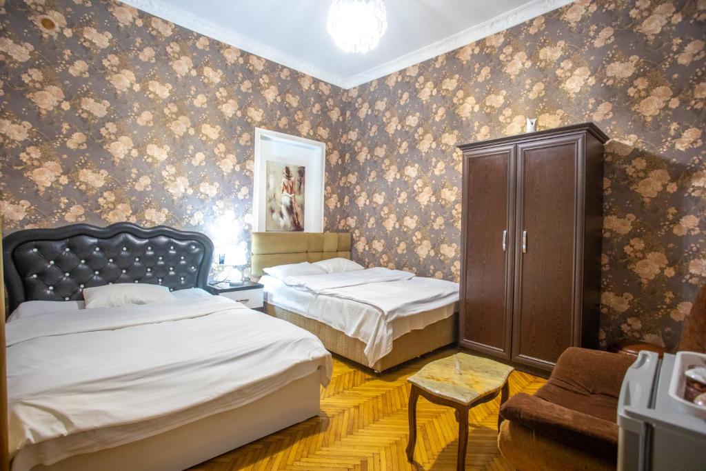 Postel nebo postele na pokoji v ubytování HOTEl MKUDRO